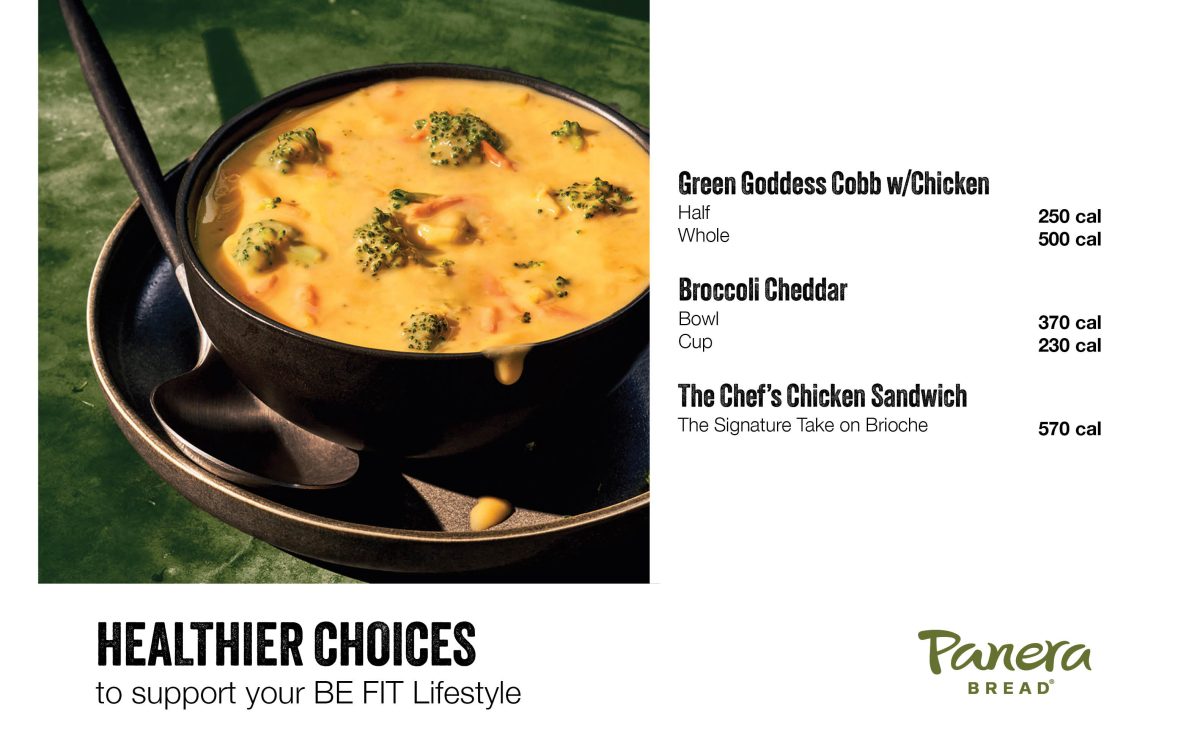 Black bowl of broccoli cheddar soup garnished with broccoli florets on a dark tray, with menu text for Green Goddess Cobb with Chicken, Broccoli Cheddar and The Chef’s Chicken Sandwich.