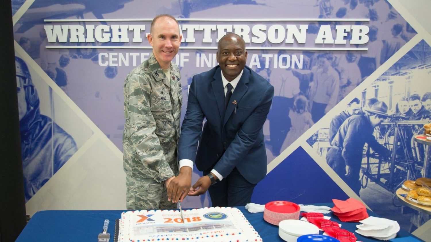 Col. Leonard T. Rose, 88th Mission Support Group commander, and Jermaine Wilson, Wright-Patterson Exchange general manager, cut a commemorative cake at the Exchange's grand re-opening ceremony Oct. 25, 2018. The event culminated a $6.4 million renovation for the nearly 40-year-old facility, which was last remodeled in 2010. (U.S. Air Force photo/John Harrington)