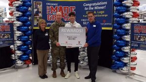 Garrison Command Sgt. Maj. Jason W. Osborne joins the Fort Campbell Exchange Store Manager Annette Montgomery and General Manager David Swenson in celebrating Elias Lugo, 14, of Clarksville, TN for his academic achievement. Elias was presented with a $2,000 Exchange gift card Feb. 1 as part of the You Made the Grade program.