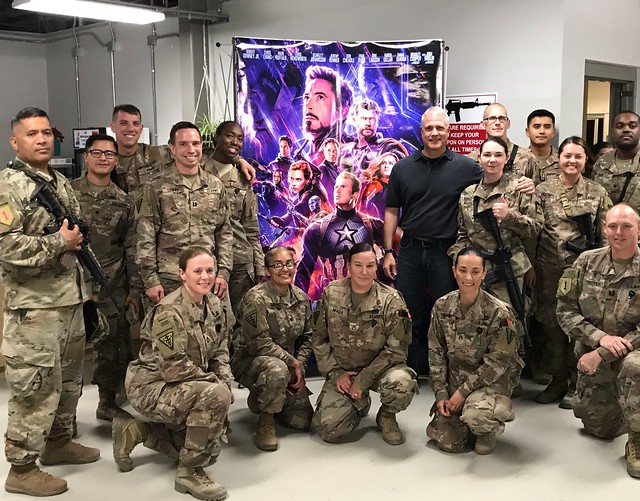 Troops in Afghanistan pose in front of an Avengers poster before a free screening of the blockbuster movie. 