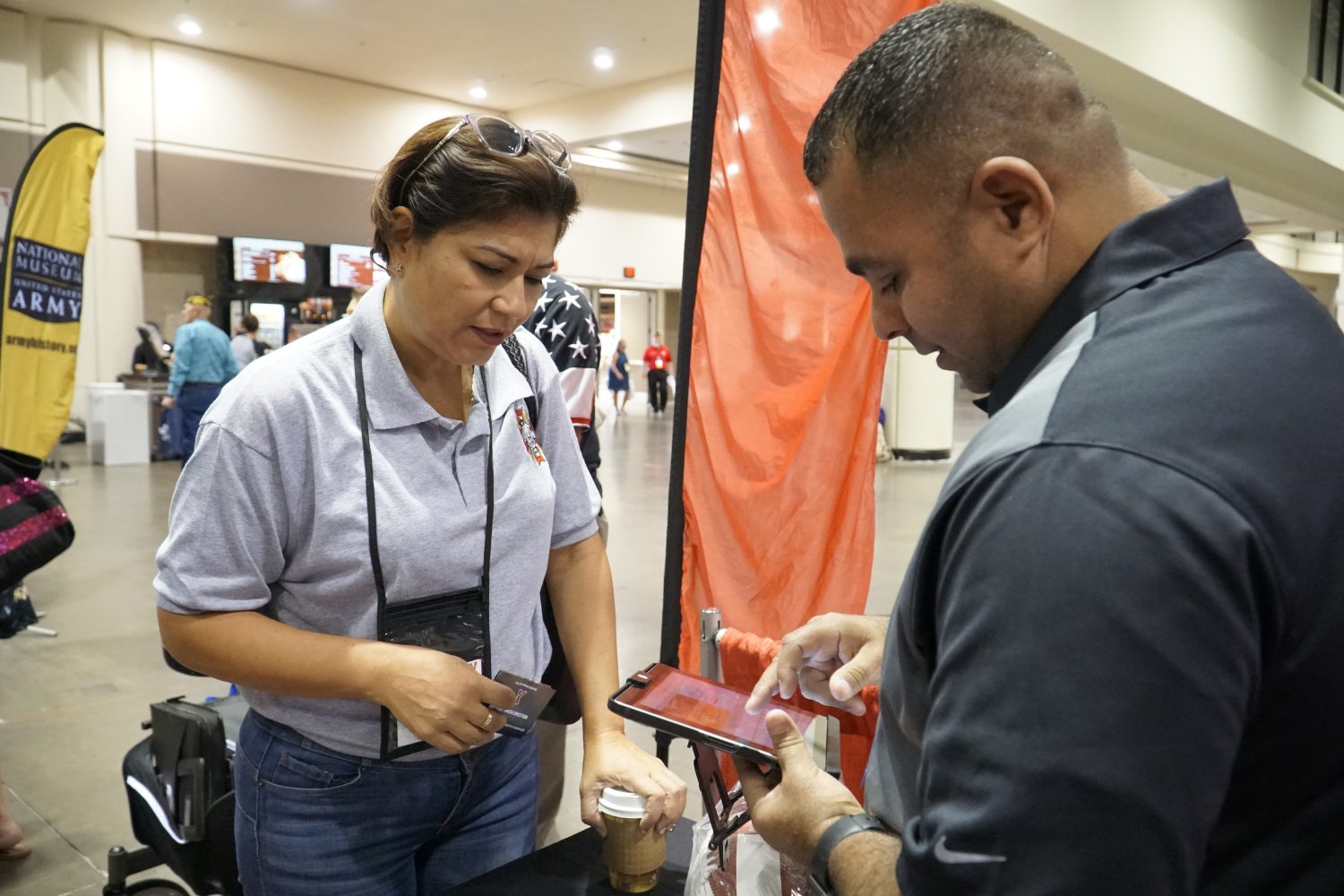 Army Veteran Francis Cordero Medina learns how to sign up for tax-free shopping at ShopMyExchange.com with help from Exchange Veteran Service 