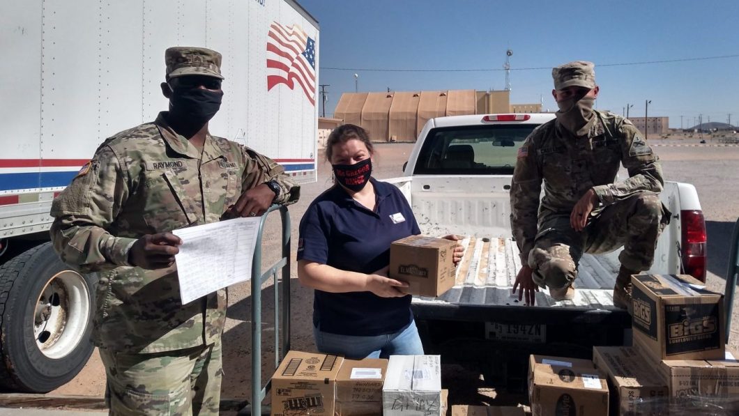 Sgt. Tehjmar Raymond (left) and Spc. Nathaniel Causley (right) help McGregor Field Troop Store Manager Tina Bretz load orders placed through the Fort Bliss Exchange’s personal shopper program onto a truck to be transported to quarantined Soldiers at Fort Bliss.