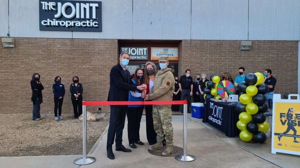 Photo of The Joint Chiropractic CEO Peter Holt, Luke Air Force Base Exchange Services Business Manager Patricia Warner, Luke AFB Exchange General Manager Sarah Park and 56th Mission Support Group Commander Col. Anthony Mullinax cutting the ribbon on The Joint Chiropractic, the first chiropractic clinic at an Army & Air Force Exchange Service PX or BX, Jan. 12 at Luke AFB.