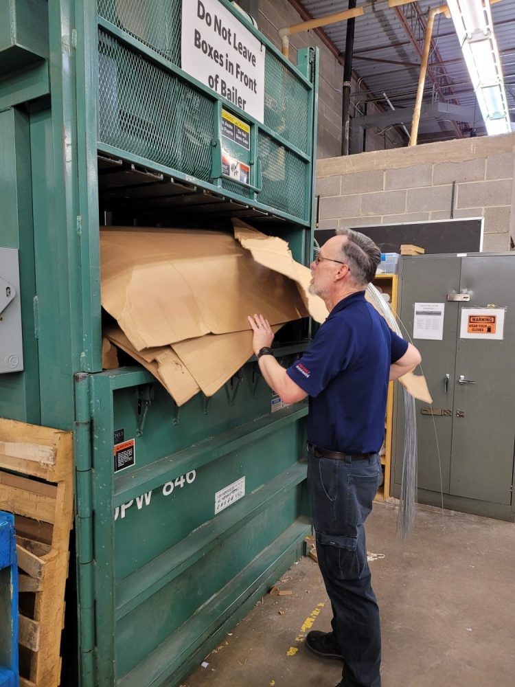 Fort Carson Exchange Military Clothing Warehouse Worker James Vick recycles cardboard, one of the many ways the Exchange reduces waste.