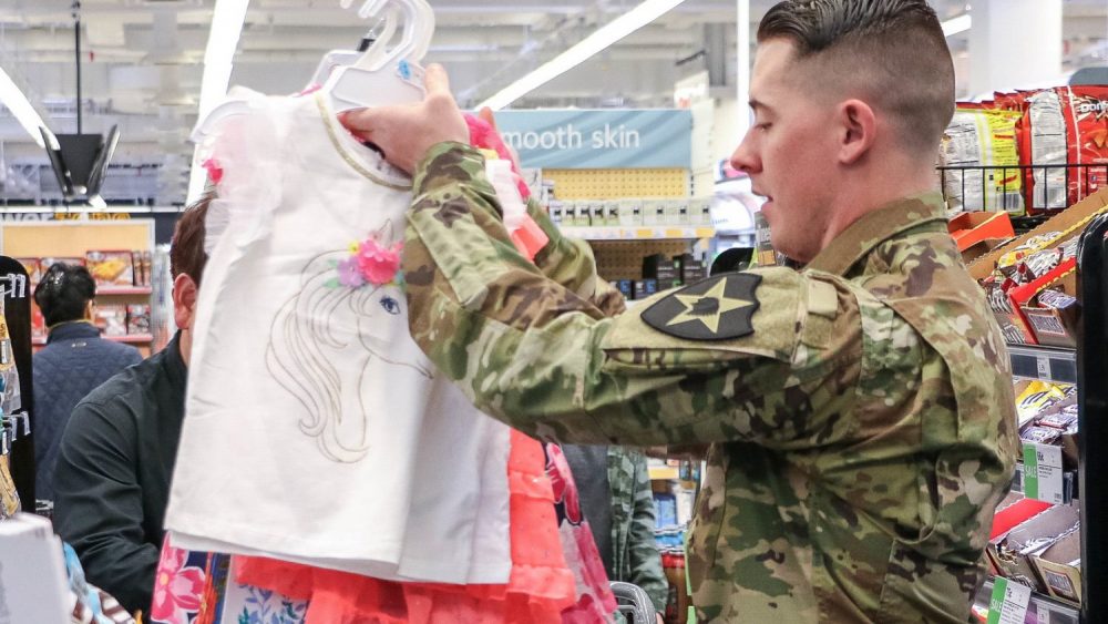 A service member browses children's clothing at an Exchange store