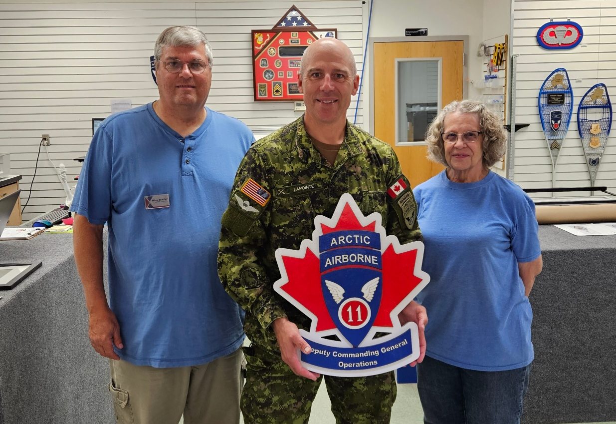 JBER Freedom Frames Managers Miles Bradley and Marcia Bradley with Brig. Gen. Louis M. Lapointe