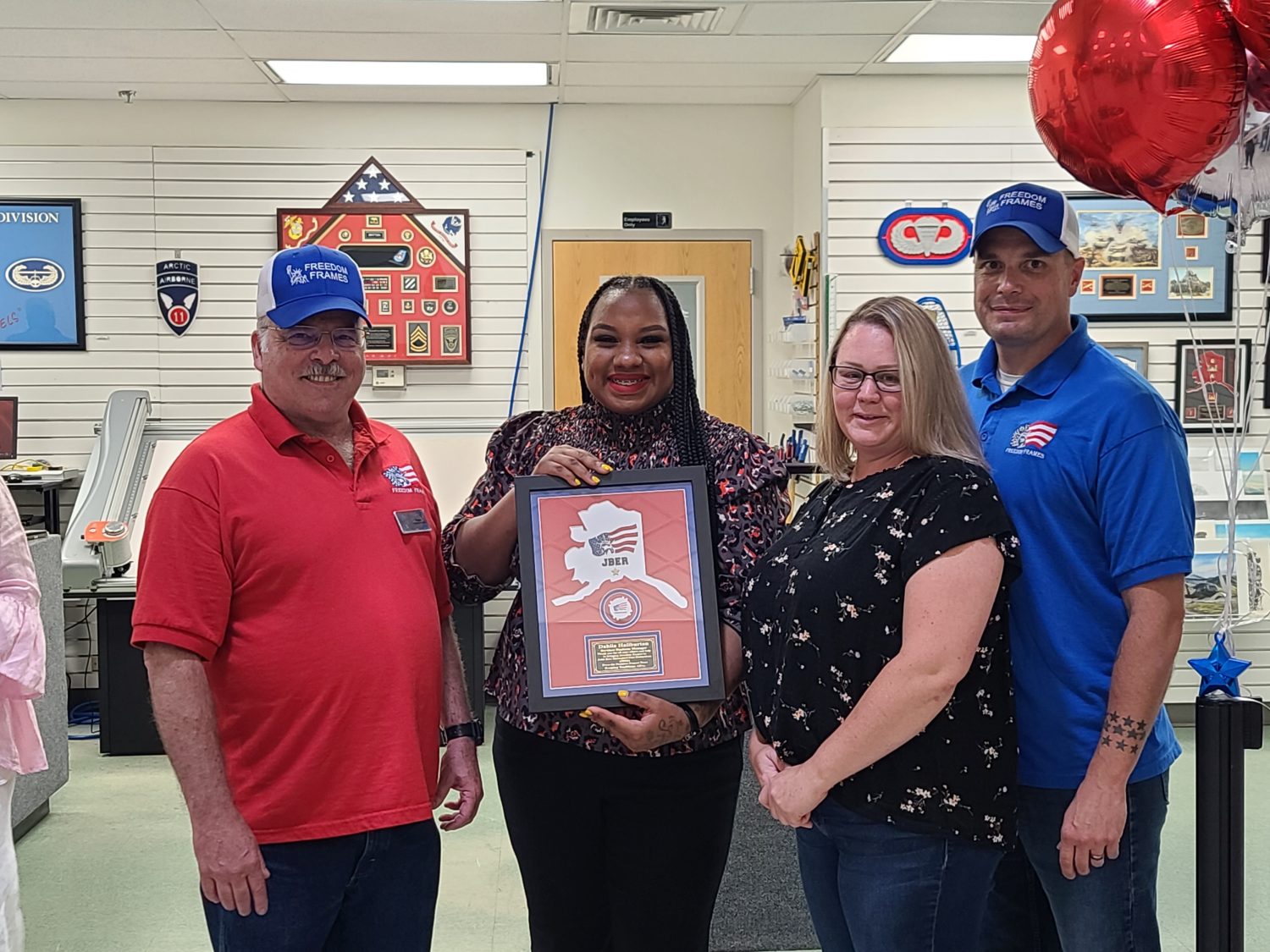 Dean Phillips Jr., JBER Exchange Services Business Manager Dahlia Haliburton, Nicole Bradley, Michael Bradley