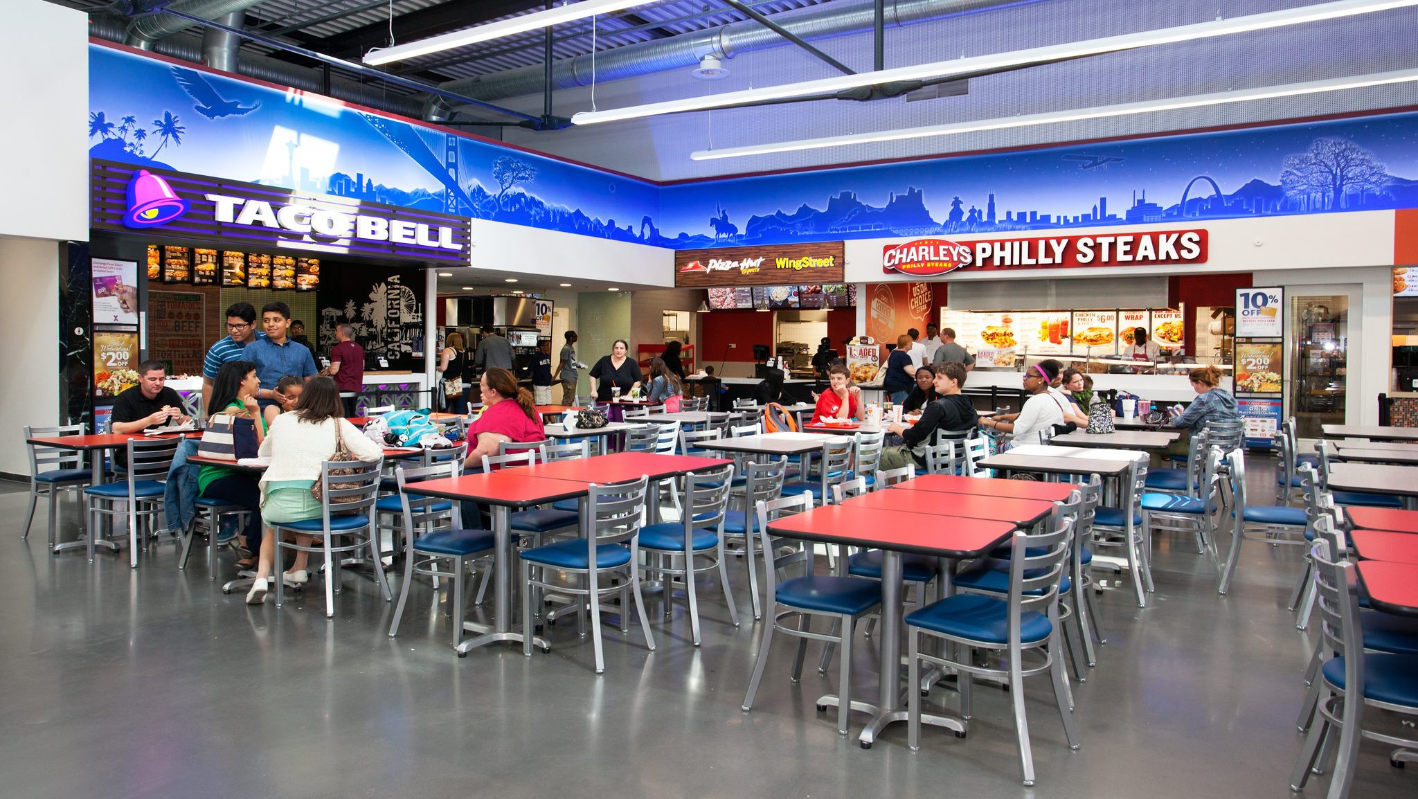 patrons at red table in food court